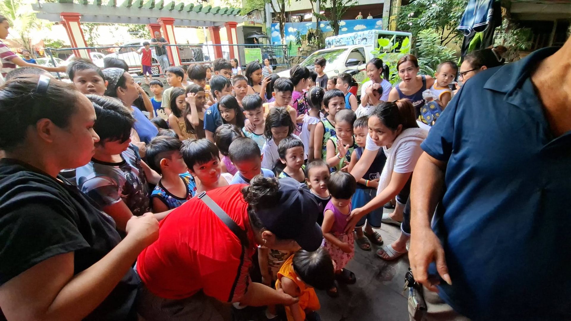Adults and children gathered together at a community event